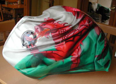 An airbrushed roaring Welsh flag dragon melts a BMW badge